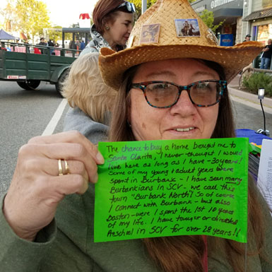 image of person holding flag with personal story written on it
