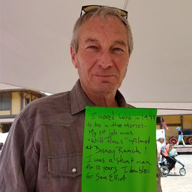 image of person holding flag with personal story written on it