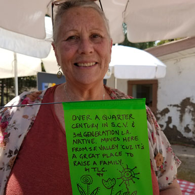 image of person holding flag with personal story written on it