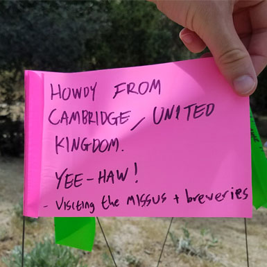 image of person holding flag with personal story written on it