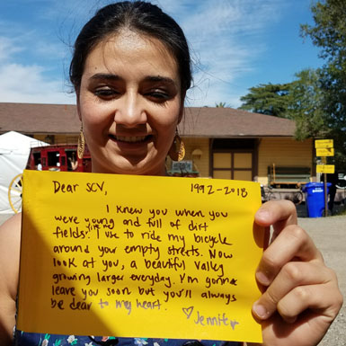 image of person holding flag with personal story written on it