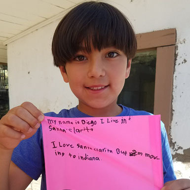 image of person holding flag with personal story written on it