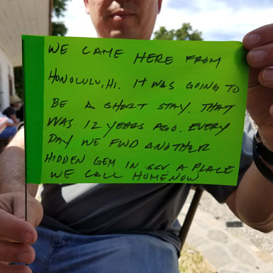 image of person holding flag with personal story written on it