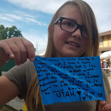 image of person holding flag with personal story written on it