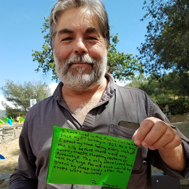 image of person holding flag with personal story written on it