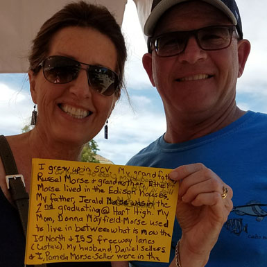 image of person holding flag with personal story written on it