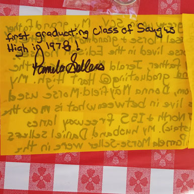 image of person holding flag with personal story written on it