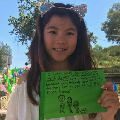 image of person holding flag with personal story written on it
