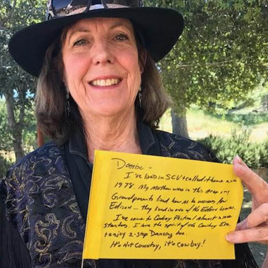 image of person holding flag with personal story written on it