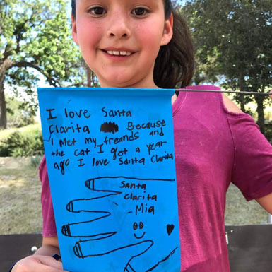 image of person holding flag with personal story written on it