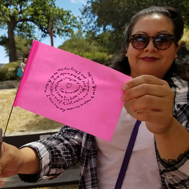 image of person holding flag with personal story written on it